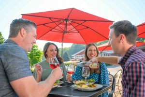 four people have wine and food at Black Star Farms