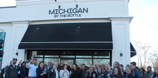 Owners, staff, and guests celebrating the opening of the new Michigan by the Bottle location in Lake Orion.